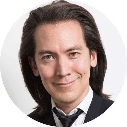 A man with long hair in a suit and tie. : top futurist keynote speakers