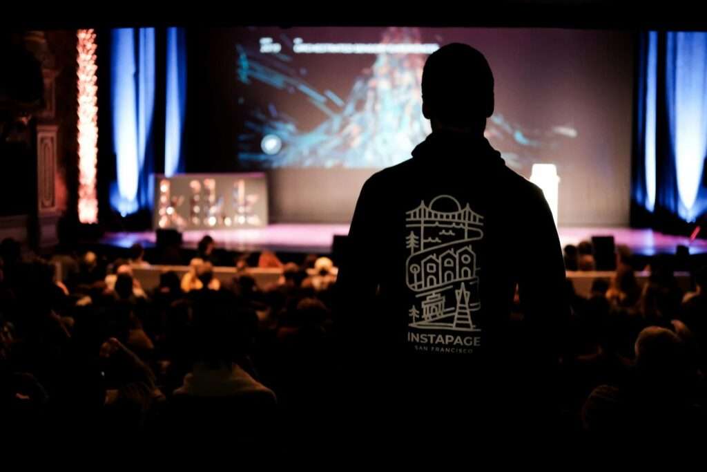A back shot of a celebrity speaker preparing to deliver a powerful keynote address at a prestigious event.